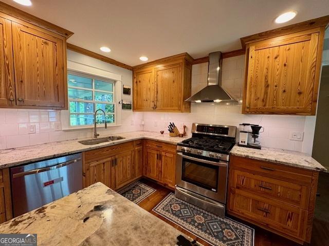 360 Morgan Mill Rd, Brooks, GA 30205 - kitchen with wall chimney exhaust hood, appliances with stainless steel finishes, light stone countertops, backsplash, and crown molding