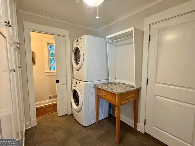360 Morgan Mill Rd, Brooks, GA 30205 - laundry room featuring estacked washer and dryer and crown molding