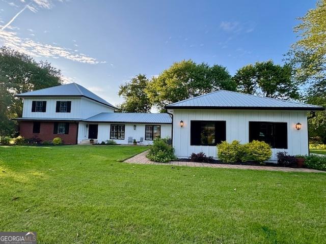 360 Morgan Mill Rd, Brooks, GA 30205 - rear view of house featuring a lawn, board and batten siding, and a metal roof