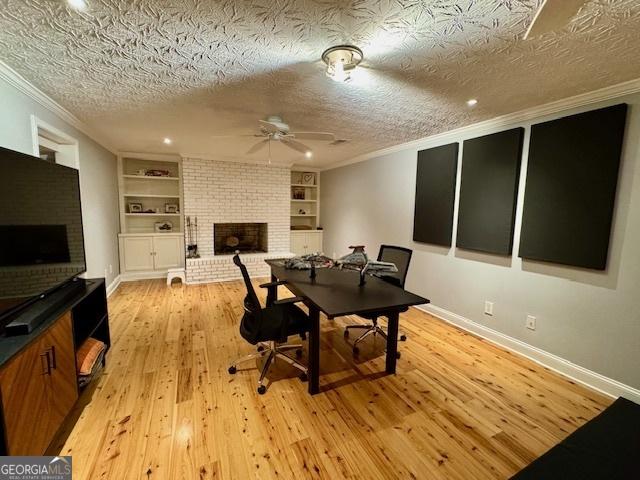 360 Morgan Mill Rd, Brooks, GA 30205 - office with a fireplace, ornamental molding, a textured ceiling, ceiling fan, and light wood-type flooring