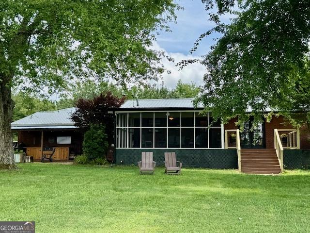 360 Morgan Mill Rd, Brooks, GA 30205 - back of house with a sunroom, a yard, stairs, and a wooden deck