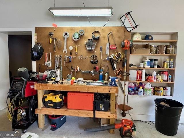 360 Morgan Mill Rd, Brooks, GA 30205 - miscellaneous room with a workshop area and concrete floors