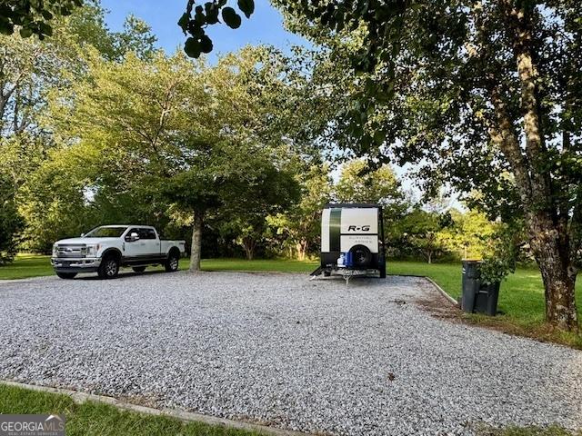 360 Morgan Mill Rd, Brooks, GA 30205 - view of vehicle parking with driveway and view of scattered trees