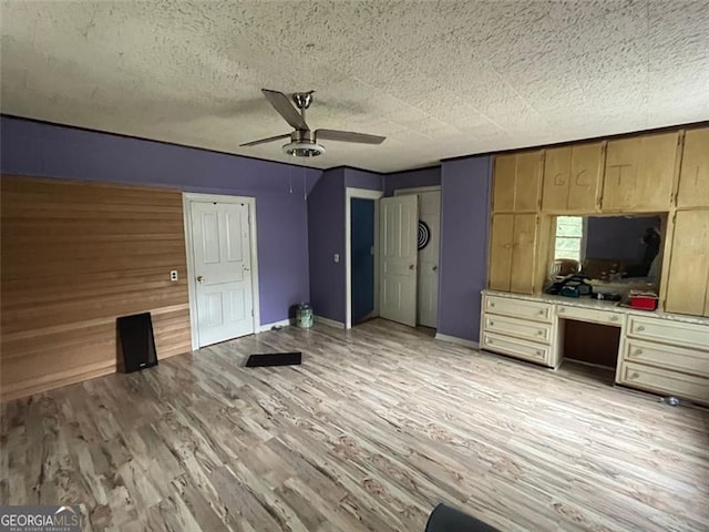 15 Liberty St, Gainesville, GA 30501 - unfurnished bedroom with light wood-type flooring, built in desk, ceiling fan, and a textured ceiling