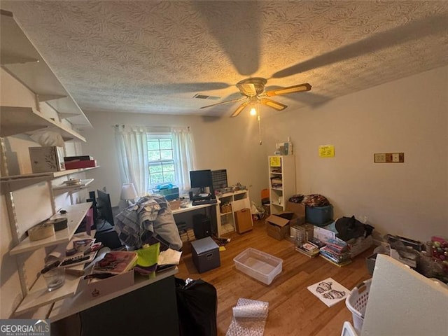 713 Pine Chase, Lawrenceville, GA 30043 - home office featuring ceiling fan, wood finished floors, and a textured ceiling