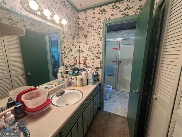 713 Pine Chase, Lawrenceville, GA 30043 - full bathroom with wallpapered walls, a closet, vanity, a shower stall, and crown molding