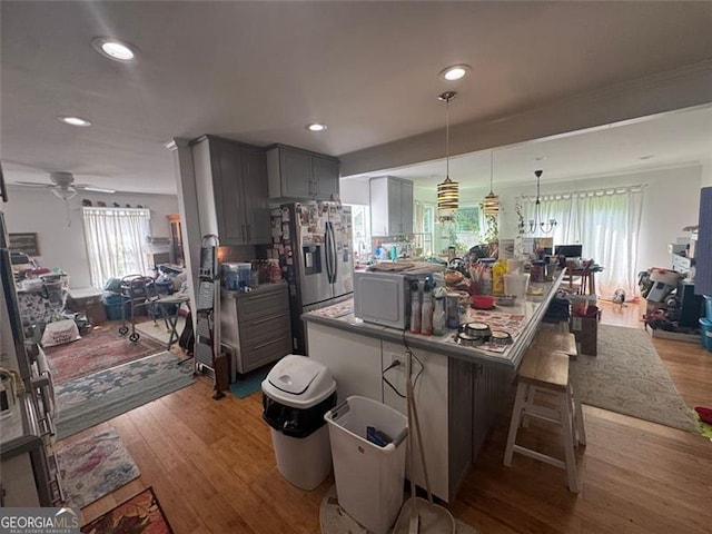 713 Pine Chase, Lawrenceville, GA 30043 - kitchen featuring stainless steel refrigerator with ice dispenser, gray cabinetry, a center island, open floor plan, and recessed lighting