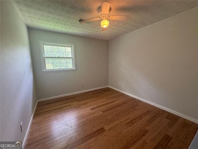 713 Pine Chase, Lawrenceville, GA 30043 - spare room with wood finished floors, a textured ceiling, and a ceiling fan