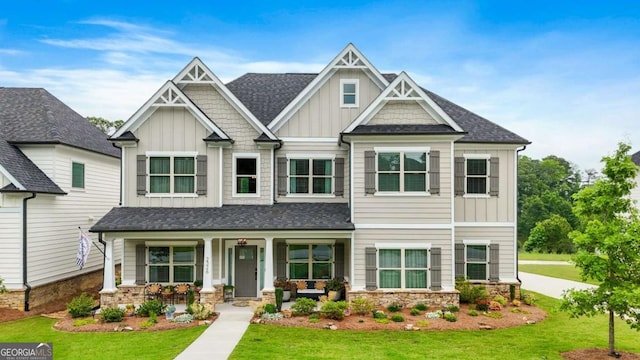 2326 Britt St, Grayson, GA 30017 - craftsman inspired home with board and batten siding, covered porch, a front lawn, stone siding, and a shingled roof
