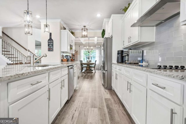 2326 Britt St, Grayson, GA 30017 - kitchen featuring extractor fan, appliances with stainless steel finishes, light wood finished floors, white cabinets, and recessed lighting