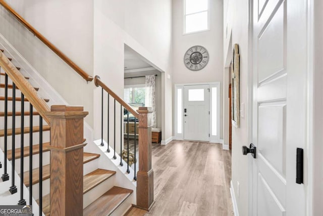 2326 Britt St, Grayson, GA 30017 - entryway featuring healthy amount of natural light, light wood-style flooring, a towering ceiling, and stairs