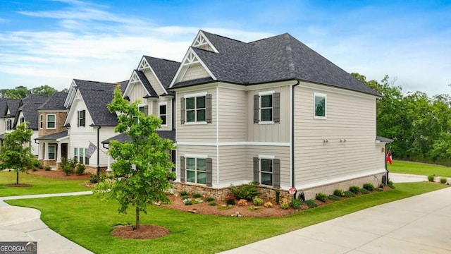 2326 Britt St, Grayson, GA 30017 - view of home's exterior featuring a yard, roof with shingles, and board and batten siding
