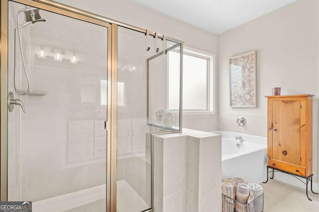 2326 Britt St, Grayson, GA 30017 - bathroom featuring a shower stall, a bath, and tile patterned flooring