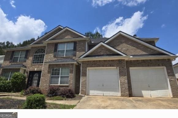 215 Gunnison Pl SW, South Fulton, GA 30331 - view of front facade with driveway, an attached garage, and brick siding