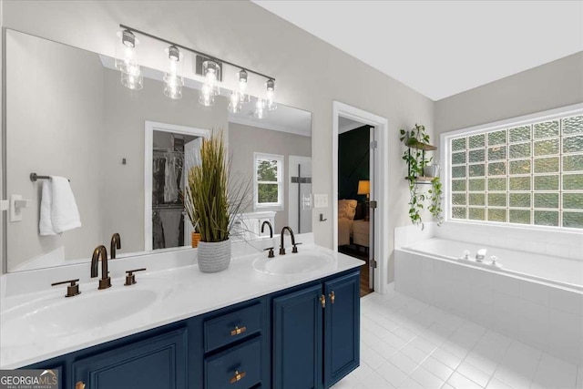 2653 W Main St NW, Atlanta, GA 30318 - ensuite bathroom with double vanity, tile patterned floors, a bath, and a spacious closet
