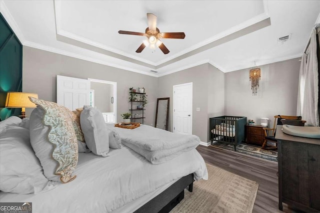2653 W Main St NW, Atlanta, GA 30318 - bedroom featuring a raised ceiling, wood finished floors, crown molding, and a ceiling fan