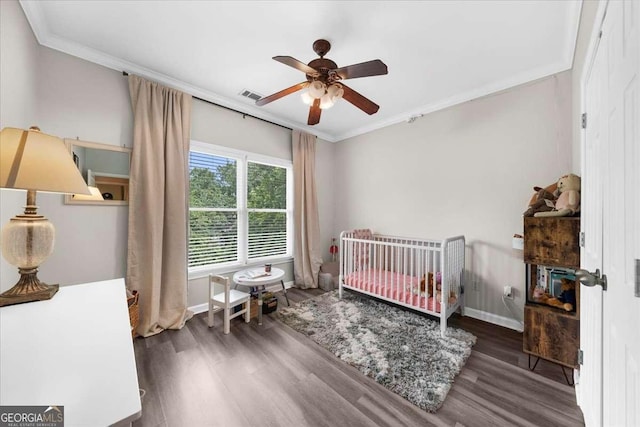 2653 W Main St NW, Atlanta, GA 30318 - bedroom featuring crown molding, wood finished floors, a crib, and ceiling fan