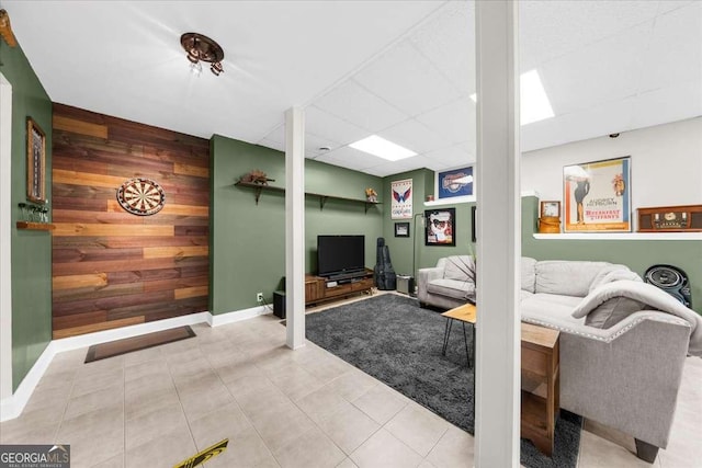2653 W Main St NW, Atlanta, GA 30318 - tiled living room featuring wooden walls, an accent wall, and a paneled ceiling