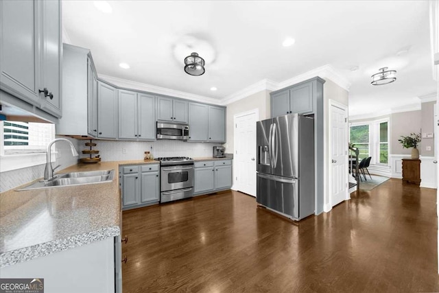 2653 W Main St NW, Atlanta, GA 30318 - kitchen featuring appliances with stainless steel finishes, ornamental molding, backsplash, dark wood finished floors, and gray cabinets