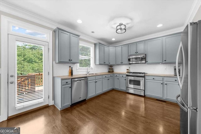 2653 W Main St NW, Atlanta, GA 30318 - kitchen featuring appliances with stainless steel finishes, gray cabinets, crown molding, decorative backsplash, and dark wood-style floors