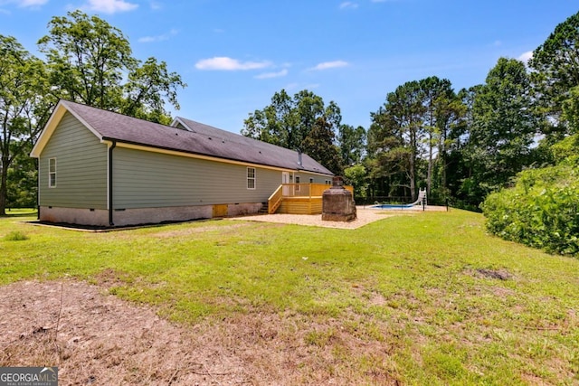 370 Simms Rd, Carrollton, GA 30117 - back of property featuring crawl space, a wooden deck, an outdoor pool, and a yard