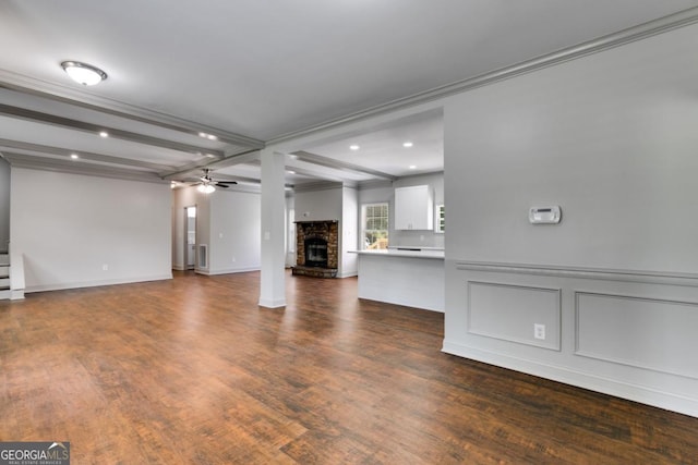 370 Simms Rd, Carrollton, GA 30117 - unfurnished living room with a fireplace, a ceiling fan, wood finished floors, crown molding, and beam ceiling