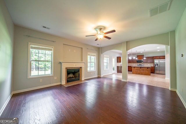 38 Pin Oak Way, Hamilton, GA 31811 - unfurnished living room with arched walkways, ceiling fan, light wood-style flooring, and a premium fireplace