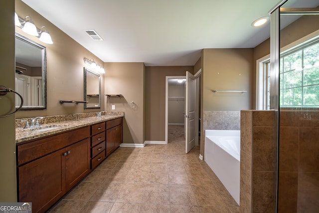 38 Pin Oak Way, Hamilton, GA 31811 - full bath with double vanity, a bath, a spacious closet, and tile patterned flooring