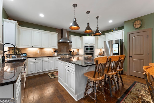 4 Bluff Ct SE, Cartersville, GA 30120 - kitchen featuring wall chimney exhaust hood, stainless steel appliances, a center island, white cabinets, and recessed lighting