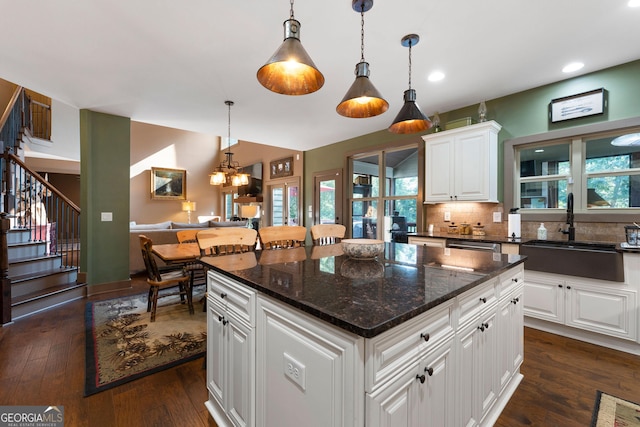 4 Bluff Ct SE, Cartersville, GA 30120 - kitchen with backsplash, a kitchen island, white cabinets, dark wood-type flooring, and pendant lighting