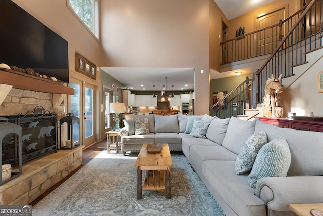 4 Bluff Ct SE, Cartersville, GA 30120 - living room with a towering ceiling, healthy amount of natural light, stairs, and a stone fireplace