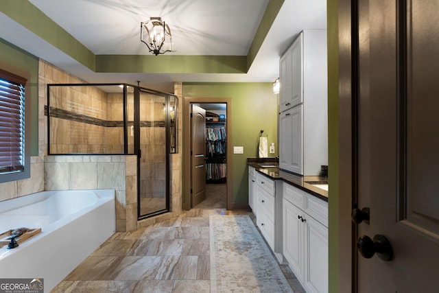 4 Bluff Ct SE, Cartersville, GA 30120 - full bath featuring vanity, a shower stall, a bath, a chandelier, and a spacious closet