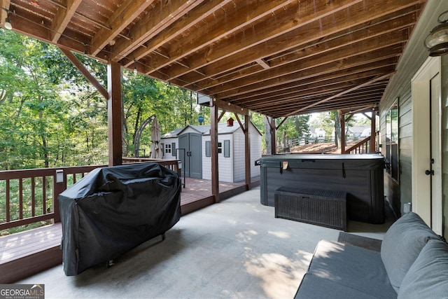 4 Bluff Ct SE, Cartersville, GA 30120 - view of patio / terrace with a storage unit, a deck, a hot tub, a grill, and view of scattered trees