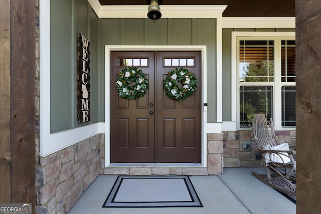 4 Bluff Ct SE, Cartersville, GA 30120 - view of exterior entry with stone siding, covered porch, and board and batten siding
