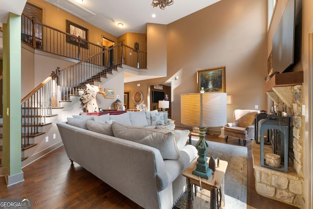 4 Bluff Ct SE, Cartersville, GA 30120 - living area featuring stairway, wood-type flooring, a towering ceiling, and a fireplace