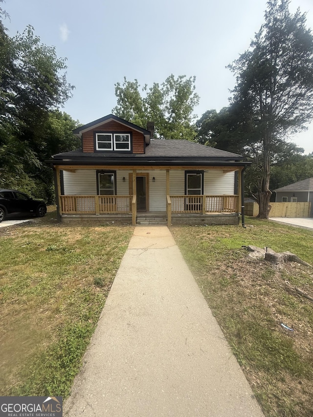 1551 Broad St NE, Conyers, GA 30012 - bungalow-style home with covered porch and a front lawn