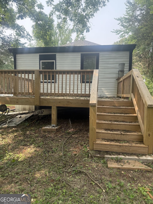 1551 Broad St NE, Conyers, GA 30012 - rear view of property featuring stairway and a wooden deck