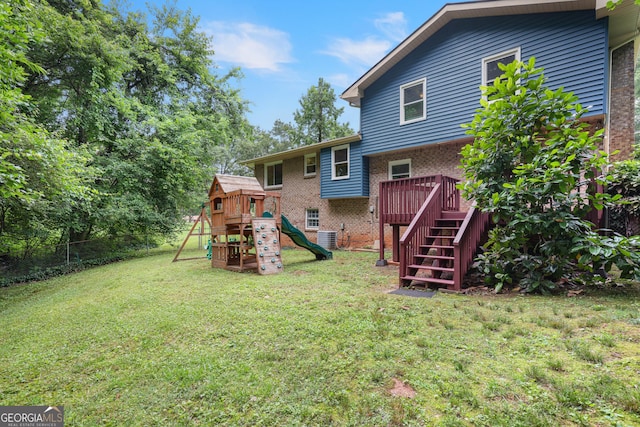 4345 Tucker N Dr, Tucker, GA 30084 - back of property with brick siding, a playground, a deck, and stairway