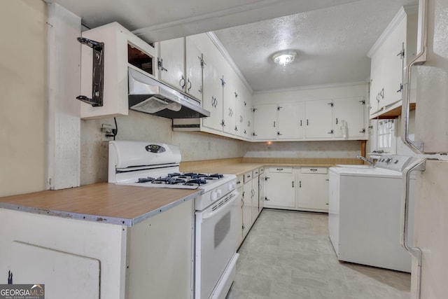 101 Leverett St, Warm Springs, GA 31830 - kitchen featuring white gas range, under cabinet range hood, washing machine and dryer, white cabinetry, and a textured ceiling