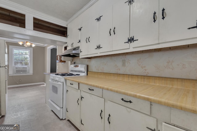 101 Leverett St, Warm Springs, GA 31830 - kitchen featuring white gas range oven, under cabinet range hood, a chandelier, white cabinets, and ornamental molding