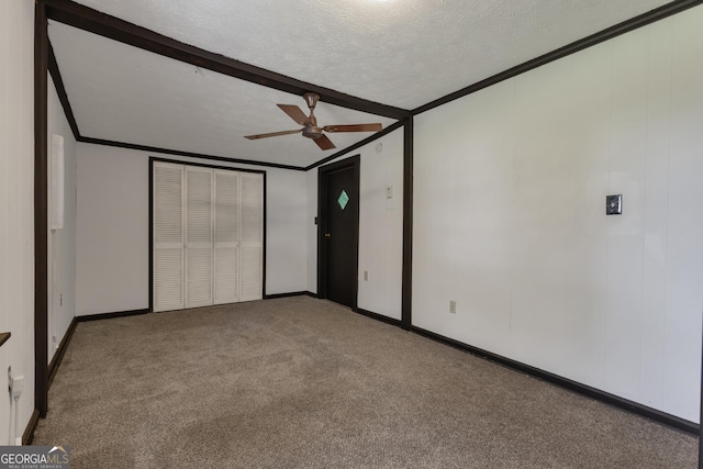101 Leverett St, Warm Springs, GA 31830 - unfurnished bedroom with crown molding, carpet flooring, ceiling fan, a closet, and a textured ceiling