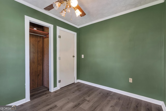 101 Leverett St, Warm Springs, GA 31830 - unfurnished bedroom featuring dark wood-style floors, a closet, crown molding, and a ceiling fan