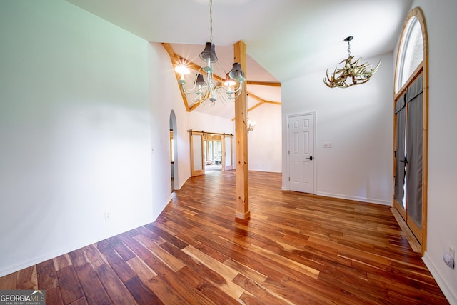 124 Old Salem Trl, Pine Mountain, GA 31822 - entryway with a chandelier, a barn door, wood finished floors, and high vaulted ceiling