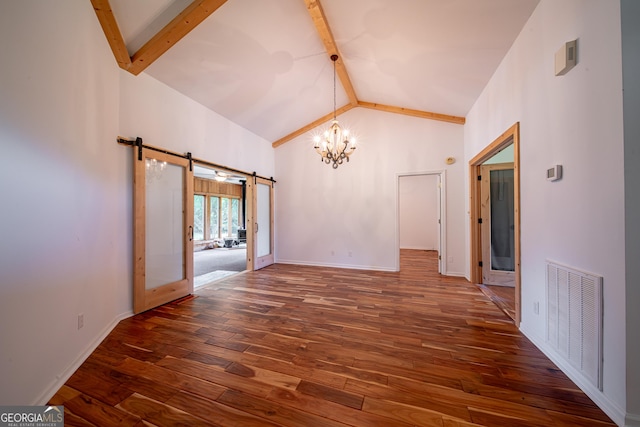 124 Old Salem Trl, Pine Mountain, GA 31822 - unfurnished living room with a barn door, a chandelier, beam ceiling, hardwood / wood-style flooring, and high vaulted ceiling