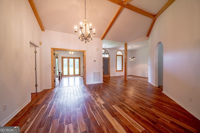 124 Old Salem Trl, Pine Mountain, GA 31822 - unfurnished living room with a chandelier, dark wood finished floors, arched walkways, beam ceiling, and high vaulted ceiling