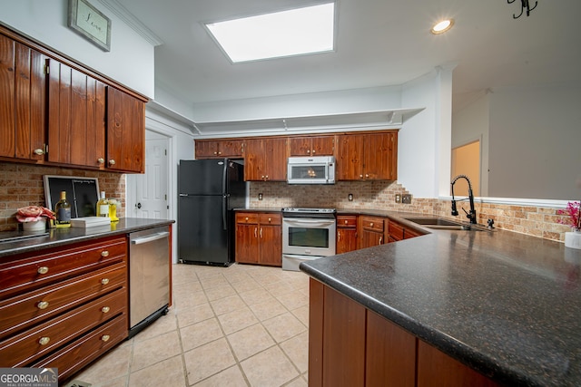 124 Old Salem Trl, Pine Mountain, GA 31822 - kitchen featuring appliances with stainless steel finishes, tasteful backsplash, light tile patterned floors, and dark countertops