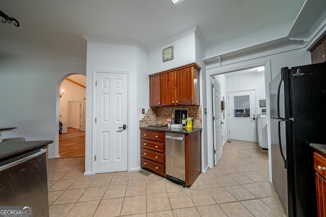 124 Old Salem Trl, Pine Mountain, GA 31822 - kitchen featuring freestanding refrigerator, arched walkways, ornamental molding, light tile patterned floors, and tasteful backsplash