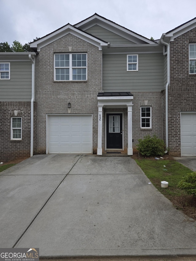 846 Hughes Trce, Stone Mountain, GA 30083 - traditional-style home featuring an attached garage, brick siding, and driveway