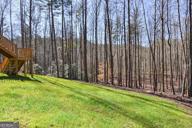 3177 Rodgers Creek Rd Unit 169, Ellijay, GA 30540 - view of green lawn with stairs, a wooden deck, and a view of trees