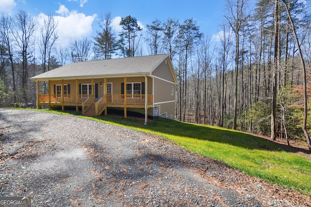 3177 Rodgers Creek Rd Unit 169, Ellijay, GA 30540 - view of front of home with a porch, a shingled roof, a forest view, and a front lawn